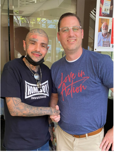 Tim Brand of Many Hands shaking hands with Mario at Homeboy Industries in Los Angeles, highlighting a partnership focused on social justice, rehabilitation, and community impact.