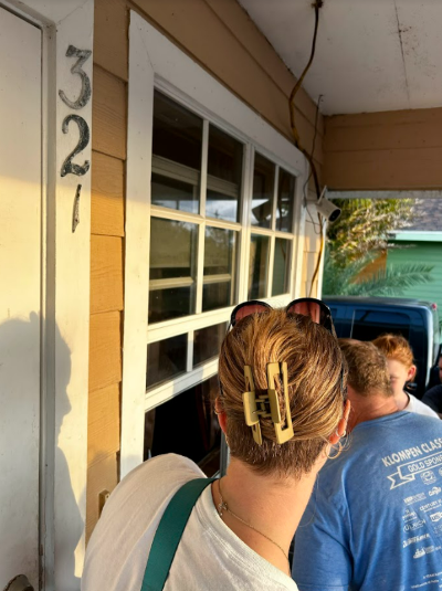 an impact team orders ice cream through a window on a front porch in abaco