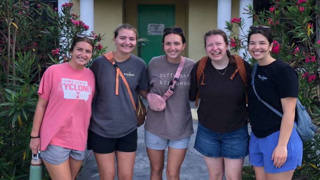Lutheran Church of Hope Ames Kairos team members stand arm-in-arm at a local Abaco school, celebrating a week of youth mobilization, kids camp ministry, and community transformation.