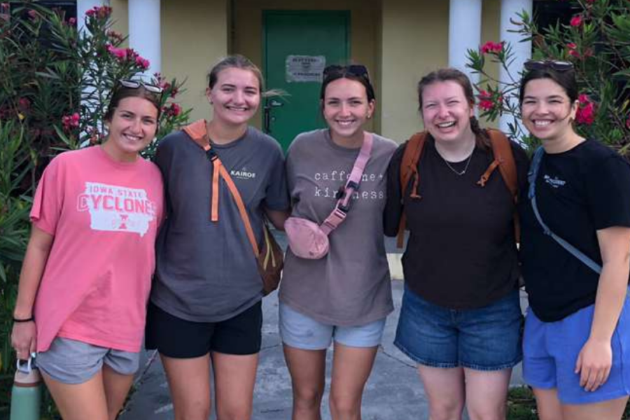 Lutheran Church of Hope Ames Kairos team members stand arm-in-arm at a local Abaco school, celebrating a week of youth mobilization, kids camp ministry, and community transformation.
