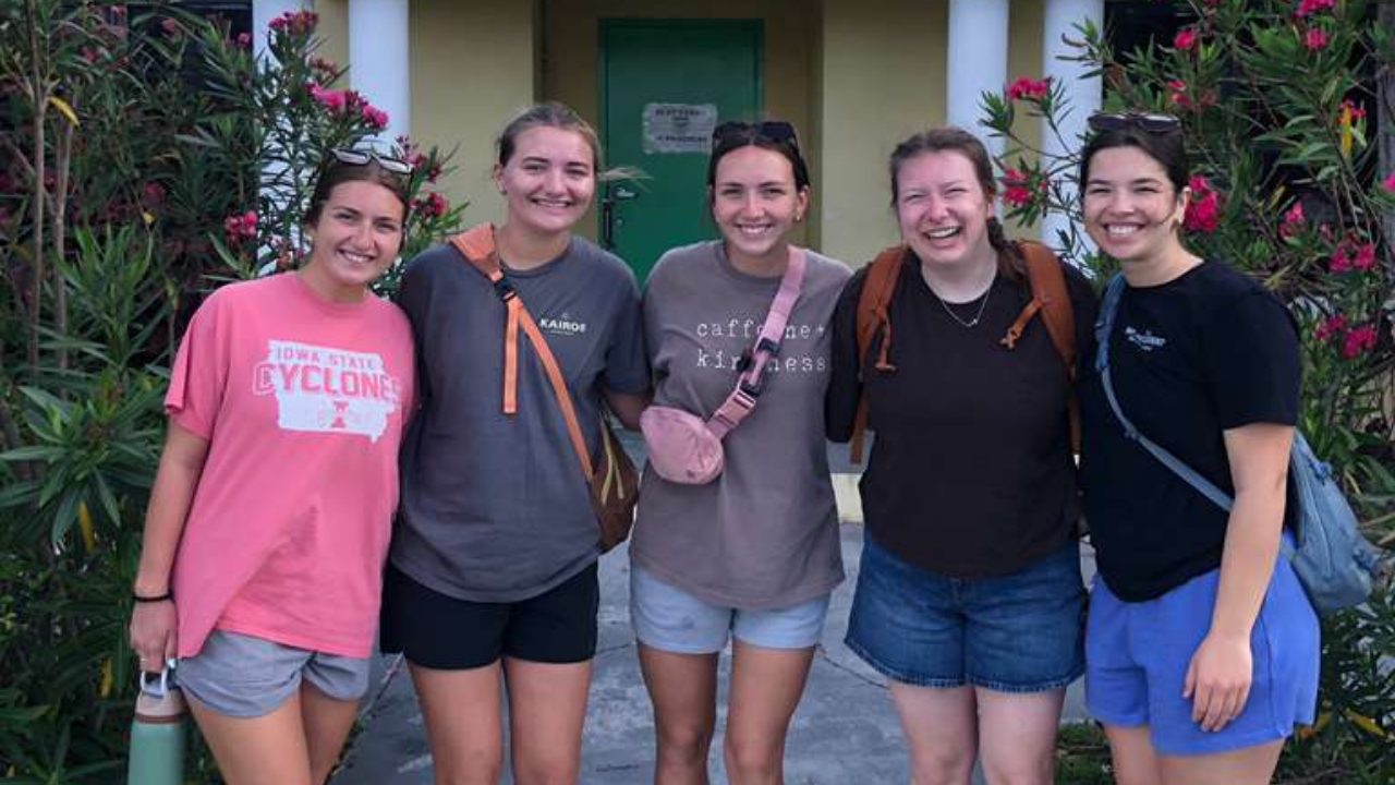 Lutheran Church of Hope Ames Kairos team members stand arm-in-arm at a local Abaco school, celebrating a week of youth mobilization, kids camp ministry, and community transformation.