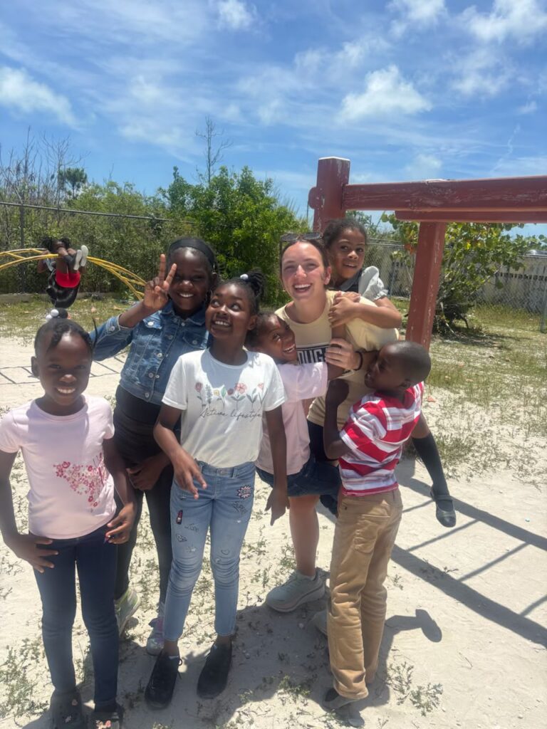 Lutheran Church of Hope Ames volunteers experience mutual joy while interacting and playing with local students during recess at a school in Abaco.