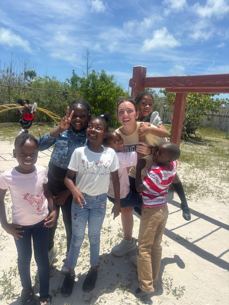 Lutheran Church of Hope Ames volunteers experience mutual joy while interacting and playing with local students during recess at a school in Abaco.