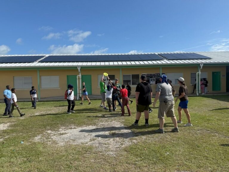 Celebrate Church short-term team members play a game of ultimate frisbee outside with local primary school students during an educational fellowship day in Abaco.