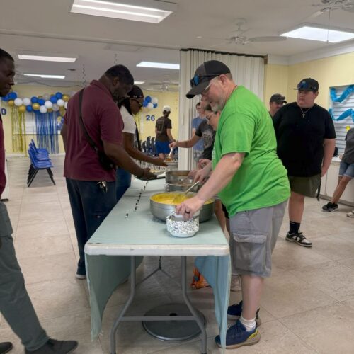 Celebrate Church impact team volunteers serve a hot breakfast to local educators and graduating students at Central Abaco Primary School (CAPS), emphasizing relational ministry and community appreciation.
