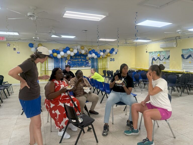 Many Hands short-term volunteers sit down with local teachers to share stories and build personal relationships over breakfast at Central Abaco Primary School.