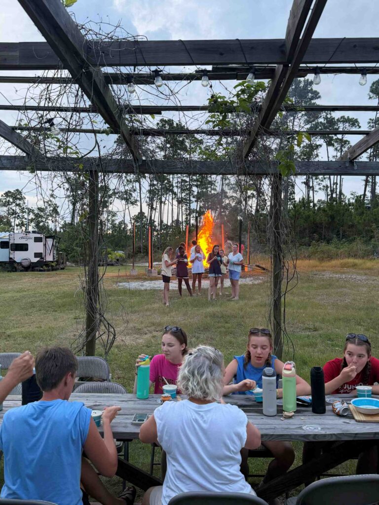 Many Hands volunteers enjoy a farm-to-table dinner and agriculture tour at Driftwood Farms, learning about local island crop production and animal sustainability.