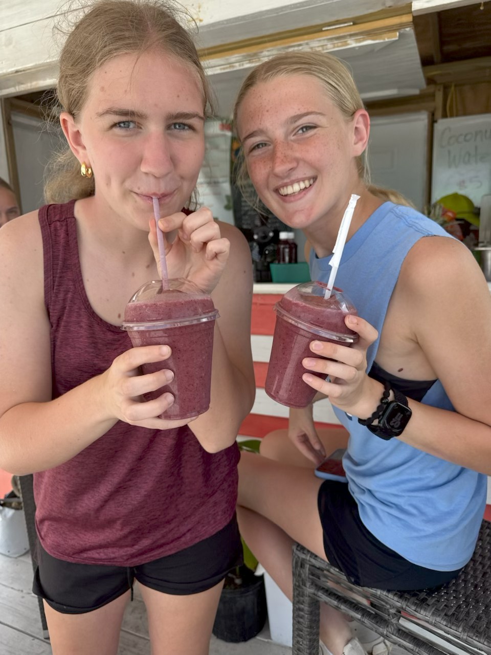 Volunteers cool off with fresh local smoothies, enjoying Bahamian hospitality and community connection after a hard day of agricultural service.
