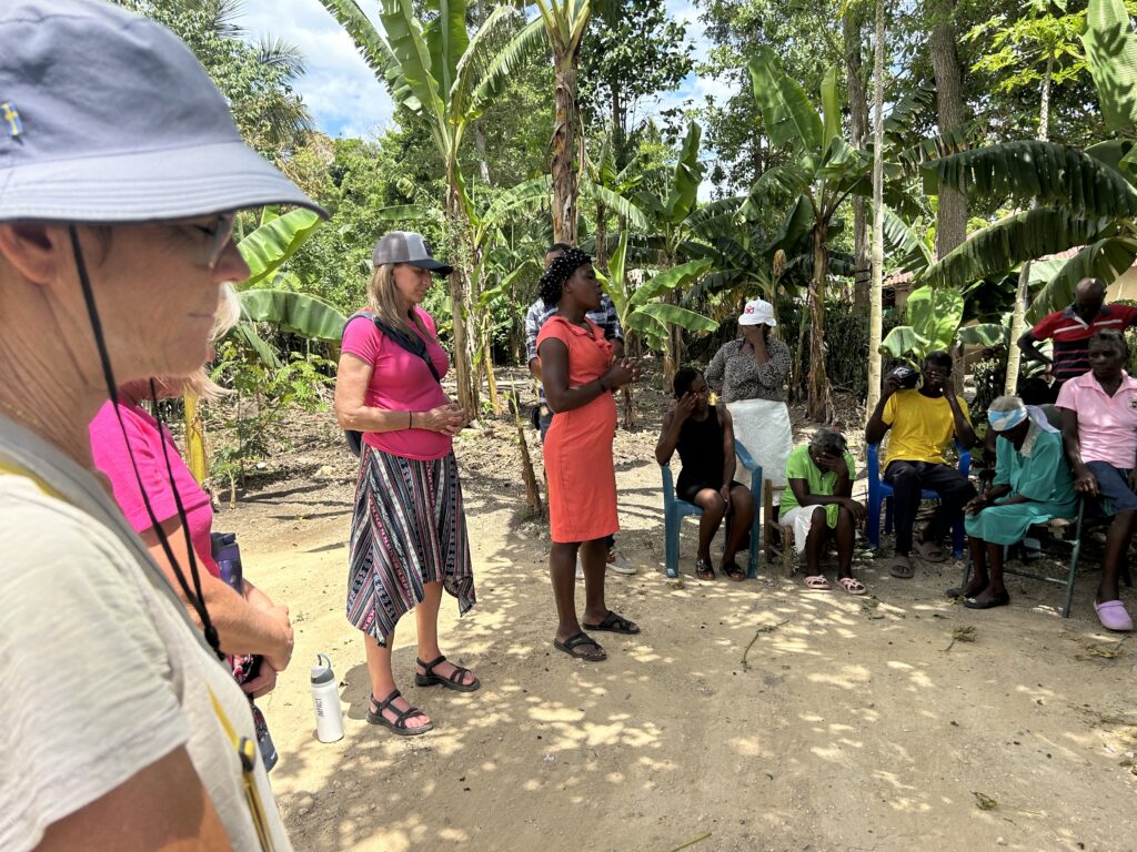 Christi and team pray with group of Haitians