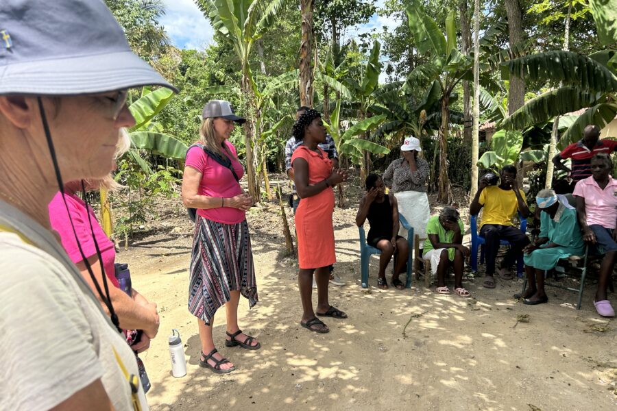 Christi and team pray with group of Haitians