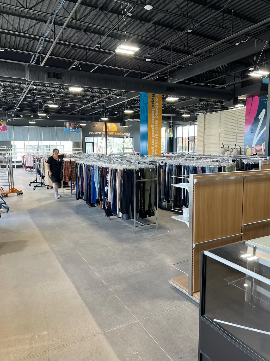 Wide interior view of the spacious sales floor and clothing racks at the new Jordan Creek Thrift Store.