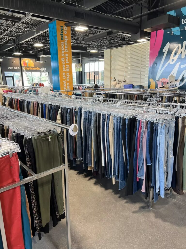 Rows of clothing racks stocked with pants and denim at the new Jordan Creek Thrift Store.
