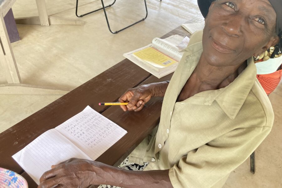 Older Haitian learns to write her own name for the first time