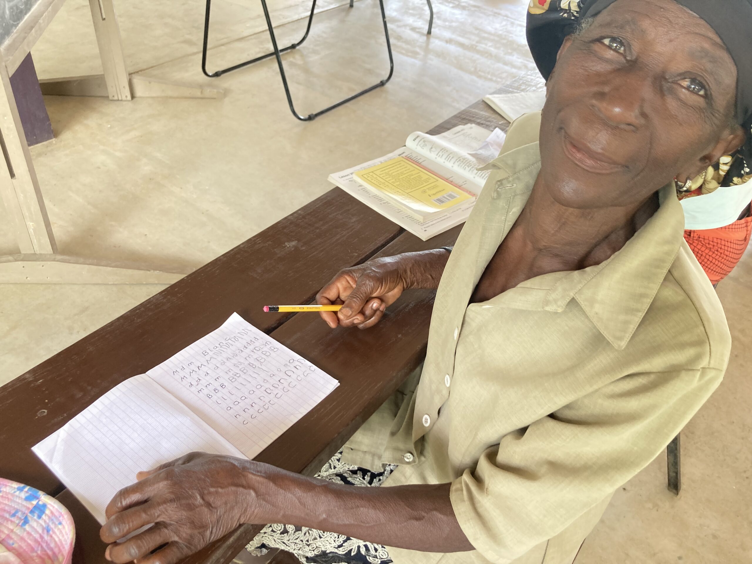 Older Haitian learns to write her own name for the first time