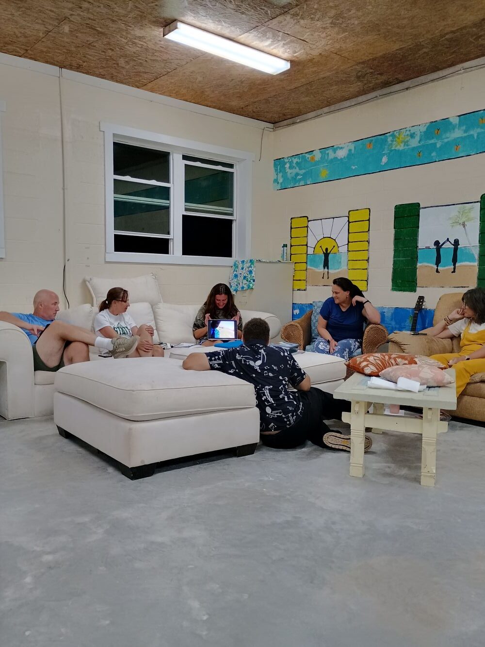 Impact team participants sit together in the gathering hall for evening devotions, heart-to-heart sharing, and daily reflection.