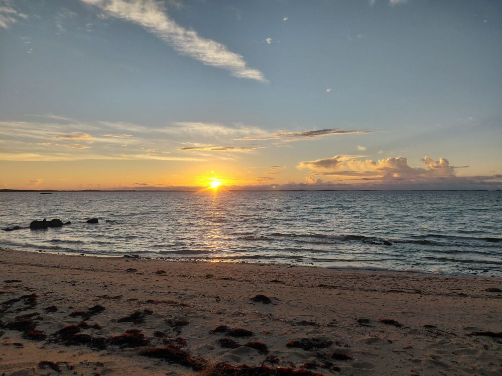 The sun sets over the ocean waters along the Abaco coastline, offering a moment of quiet reflection and renewal for impact team members.